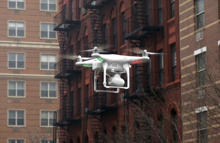A camera drone flown by Brian Wilson flies near the scene where two buildings were destroyed in an explosion, in the East Harlem section in New York City, March 12, 2014. Two New York buildings collapsed on Wednesday in an explosion believed to be caused by a gas leak, killing two people, injuring at least 22, and setting off a search for more feared trapped in the debris, officials said. REUTERS/Mike Segar (UNITED STATES - Tags: DISASTER SCIENCE TECHNOLOGY)