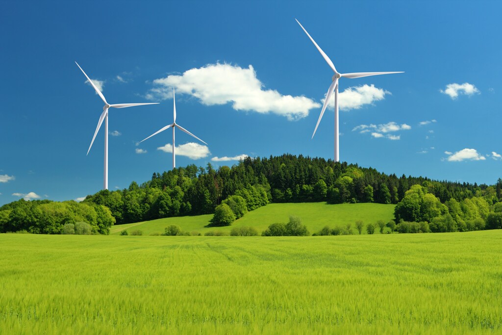 Green transition: wind turbines on a green hill.