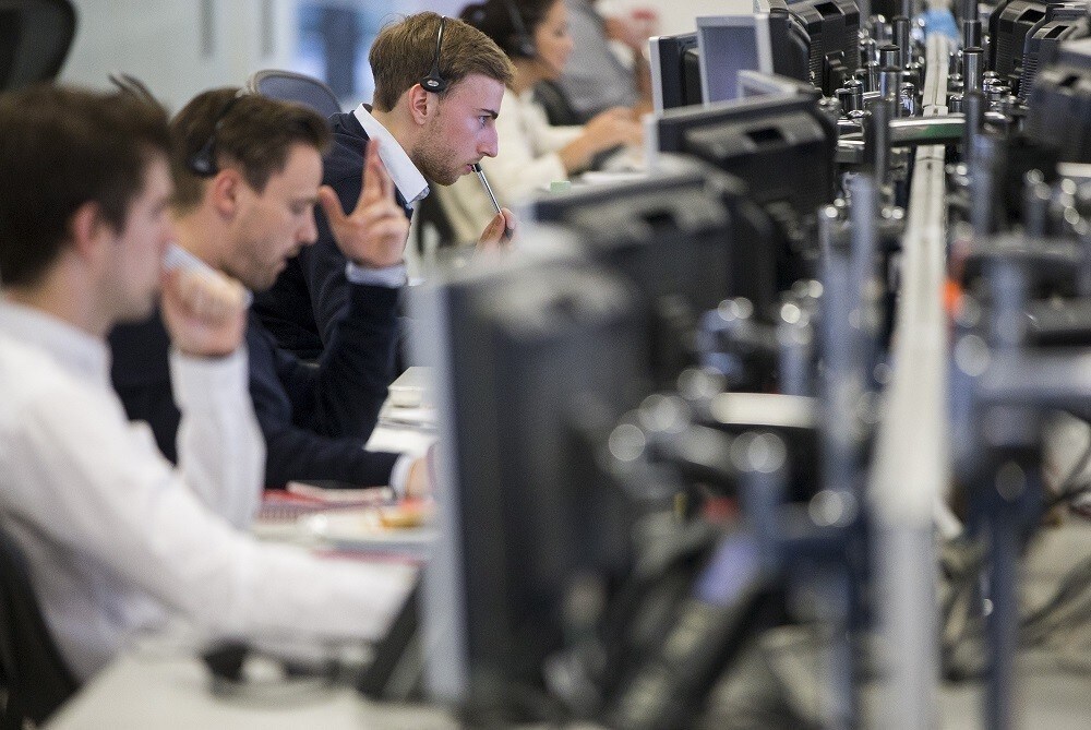 Dealers work on the IG Group trading floor in London, Britain June 30, 2015. Euro zone stocks and low-rated bonds recovered the worst of their losses on Tuesday but remained on edge as Greece looked set to default on a debt repayment to the IMF and plunge deeper into financial crisis.