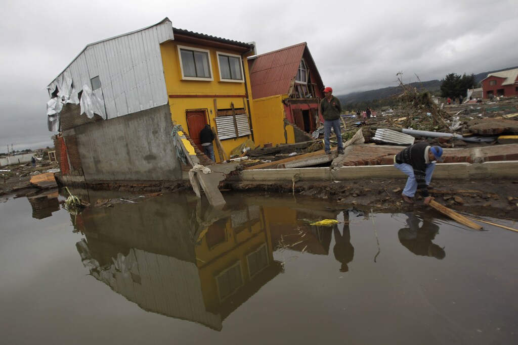 Residents inspect the destruction caused by waves generated by a major earthquake, near the epicenter in Pelluhue, February 28, 2010. The death toll from Saturday's 8.8-magnitude quake already stood at 400 before news of the devastation in Constitucion. The quake, one of the world's most powerful in a century, has dealt a serious blow to infrastructure in the world's No. 1 copper producer and one of Latin America's most stable economies. AII REUTERS/Ivan Alvarado (CHILE - Tags: DISASTER ENVIRONMENT)