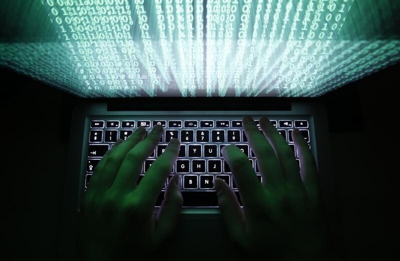 A man types on a computer keyboard in Warsaw in this February 28, 2013 illustration file picture. One of the largest ever cyber attacks is slowing global internet services after an organisation blocking "spam" content became a target, with some experts saying the disruption could get worse. To match INTERNET-ATTACK/ REUTERS/Kacper Pempel/Files (POLAND - Tags: BUSINESS SCIENCE TECHNOLOGY) - RTXXZVX
