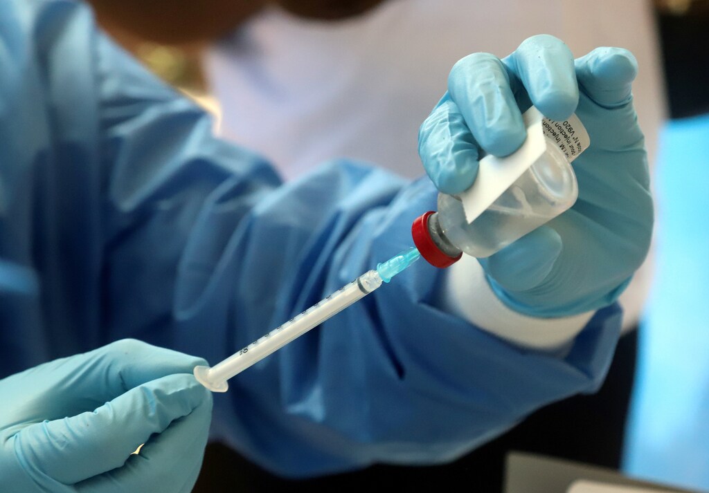 A World Health Organization worker prepares an Ebola vaccination in the Democratic Republic of Congo