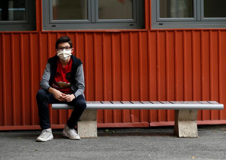 A student, wearing protective face mask, sits in the courtyard at the College Sasserno school during its reopening in Nice as a small part of French shoolchildren head back to their schools with new rules and social distancing during the outbreak of the coronavirus disease (COVID-19) in France, May 19, 2020.