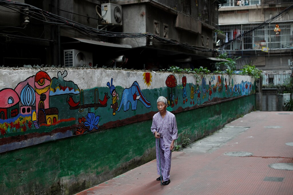 A woman walks at the traditional neighbourhood of Yuexiu in Guanghzou, China, September 8, 2019. REUTERS/Jorge Silva - RC1240E47E80