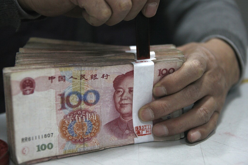 An employee seals a stack of yuan banknotes at a branch of Industrial and Commercial Bank of China in Huaibei, Anhui province April 6, 2011. Chinese inflation may top an annual rate of 6 percent in the coming months, preventing any relaxation of monetary tightening, the official China Securities Journal said on Wednesday, a day after the central bank raised interest rates for the fourth time since October. REUTERS/Stringer (CHINA - Tags: BUSINESS) CHINA OUT. NO COMMERCIAL OR EDITORIAL SALES IN CHINA - GM1E7461ANQ01