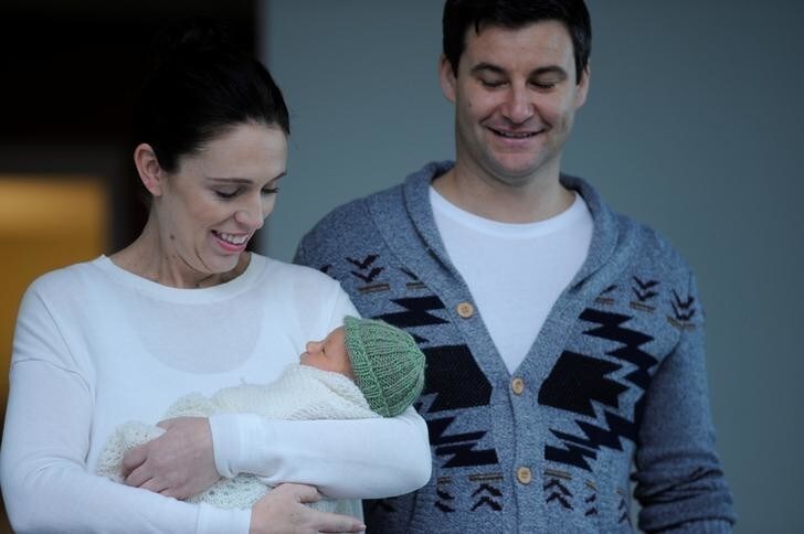 New Zealand Prime Minister Jacinda Ardern carries her newborn baby Neve Te Aroha Ardern Gayford with partner Clarke Gayford as she walks out of the Auckland Hospital in New Zealand, June 24, 2018. REUTERS/Ross Land