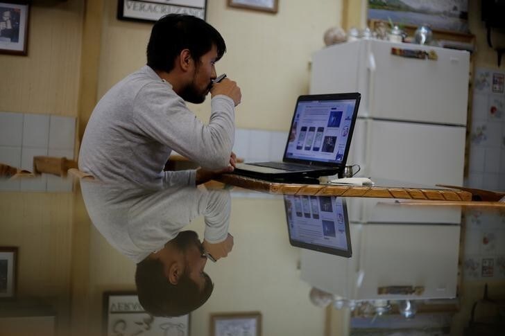 A man works on his computer at a coffee shop in Ciudad Juarez, October 19, 2017. Picture taken October 19, 2017. REUTERS/Jose Luis Gonzalez