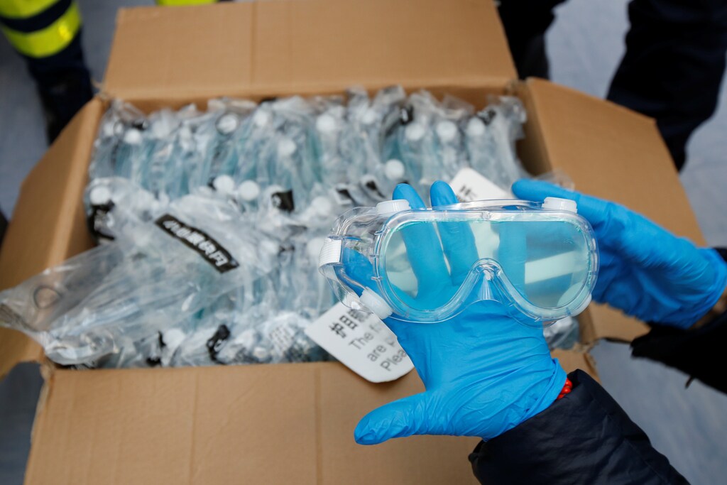 Protective goggles are inspected after arriving in travelled from Guangzhou, China, with boxes of tonnes of supplies of personal protective equipment (PPE) to help the southern Italian region of Puglia combat a spread of the coronavirus disease (COVID-19), in Bari, Italy, April 7, 2020. REUTERS/Alessandro Garofalo - RC2SZF9L3IJ5