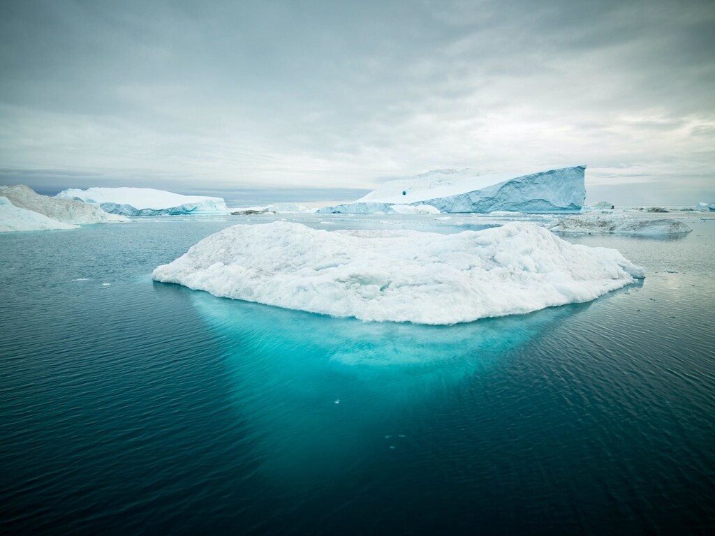 Arctic Icebergs in Greenland; Global warming: The North and South Poles experienced unprecedented heatwaves in 2022.
