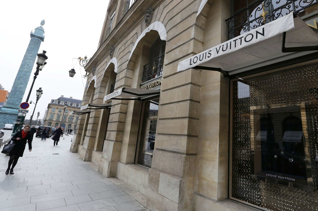 A woman walks past a store of the Louis Vuitton brand in Paris, France, March 3, 2017. REUTERS/Regis Duvignau - RTS11BQV