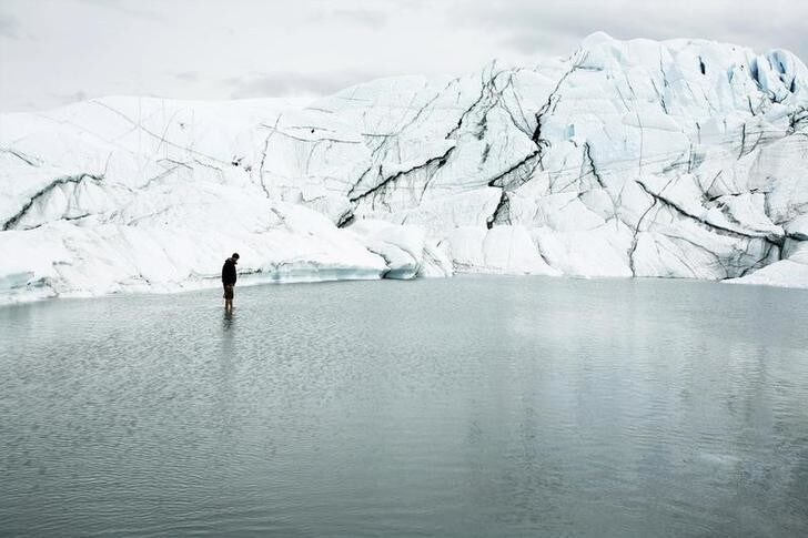 Hikers walk on the Matanuska Glacier near Palmer, Alaska August, 10 2008. The vast amounts of water stored in glaciers play crucial roles in river flows, hydropower generation and agricultural production, contributing to steady run-off for Ganges, Yangtze, Mekong and Indus rivers in Asia and elsewhere. To match feature CLIMATE-GLACIERS/ REUTERS/Lucas Jackson/Files (UNITED STATES - Tags: ENVIRONMENT SCI TECH TRAVEL)
