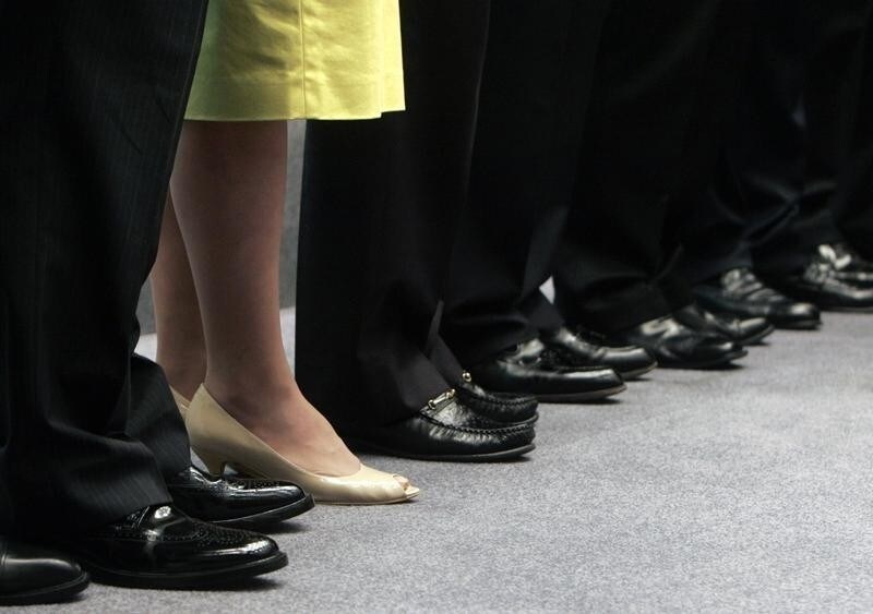 Secretary for the Civil Service Denise Yue (2nd L) stands beside other officials during a news conference in Hong Kong.