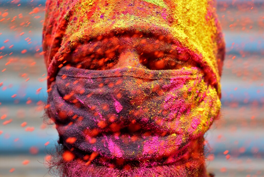 India A man wearing a protective face mask reacts as colour powder is thrown towards him during Holi celebrations, amidst the spread of the coronavirus disease (COVID-19), in Chennai, India, March 29, 2021. REUTERS/P. Ravikumar TPX IMAGES OF THE DAY - RC2VKM9V2XKQ