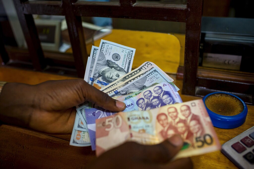 Trading US dollars for Ghanaian cedis at a currency exchange office in Accra, Ghana.