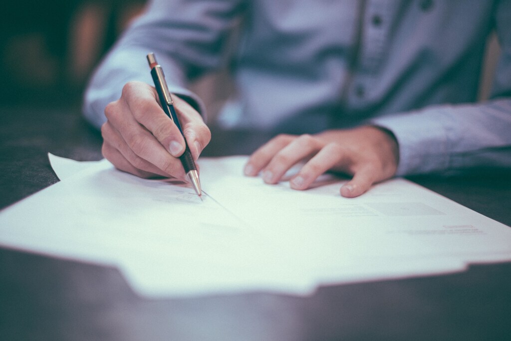 A person writing paperwork.