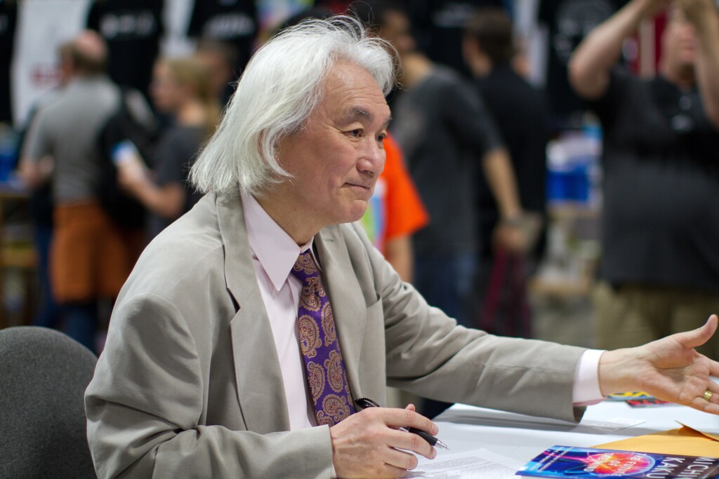 Michio Kaku sitting at a crowded event