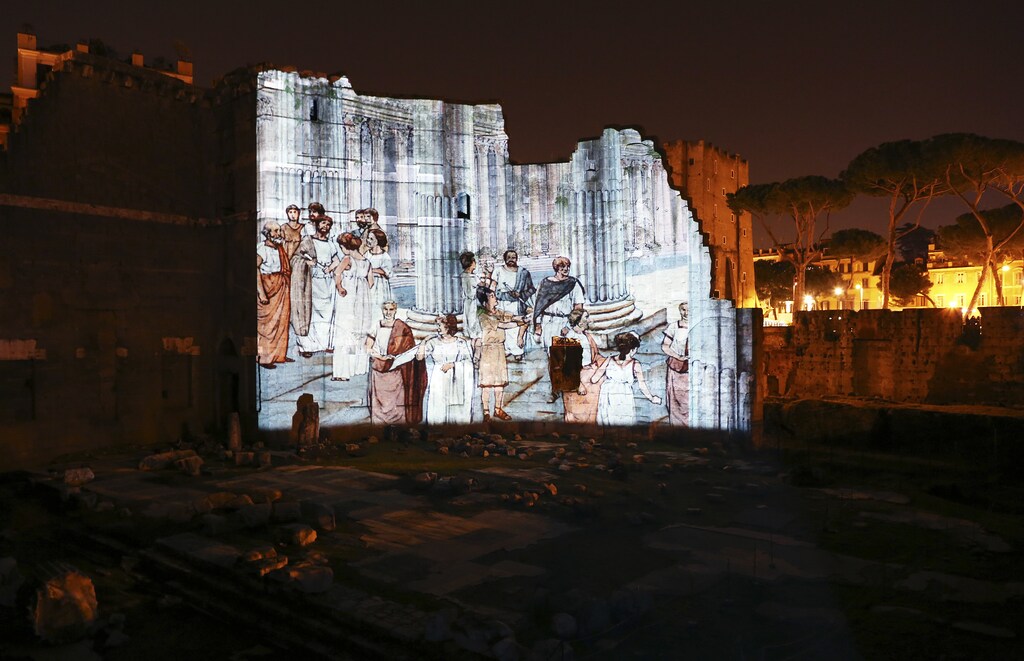 A projection shows life as it probably was 2,000 years ago in the Forum of Augustus in ancient Rome April 21, 2014. Rome, a city that thinks in millennia, is going through a bout of "Augustus fever" to mark the 2,000th anniversary of the death of its first emperor, who left his mark on Rome and Western civilisation like few others. The Eternal City is staging shows, exhibitions, debates and seminars on Augustus, who died on August 19, 14 AD at the age of 75 after a 41-year reign that was the longest in Roman history. Picture taken April 21, 2014. REUTERS/Alessandro Bianchi (ITALY - Tags: SOCIETY ANNIVERSARY) - GM1EA4U1BG501