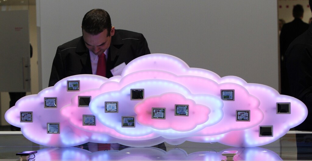 A staff member checks a display to demonstrate cloud computing with mobile phones at the booth of German company Deutsche Telekom during preparations at the CeBit computer fair in Hanover, March, 5, 2012. The biggest fair of its kind open its doors to the public on March 6 and will run to March 10: The biggest new services trade barriers are regulatory differences