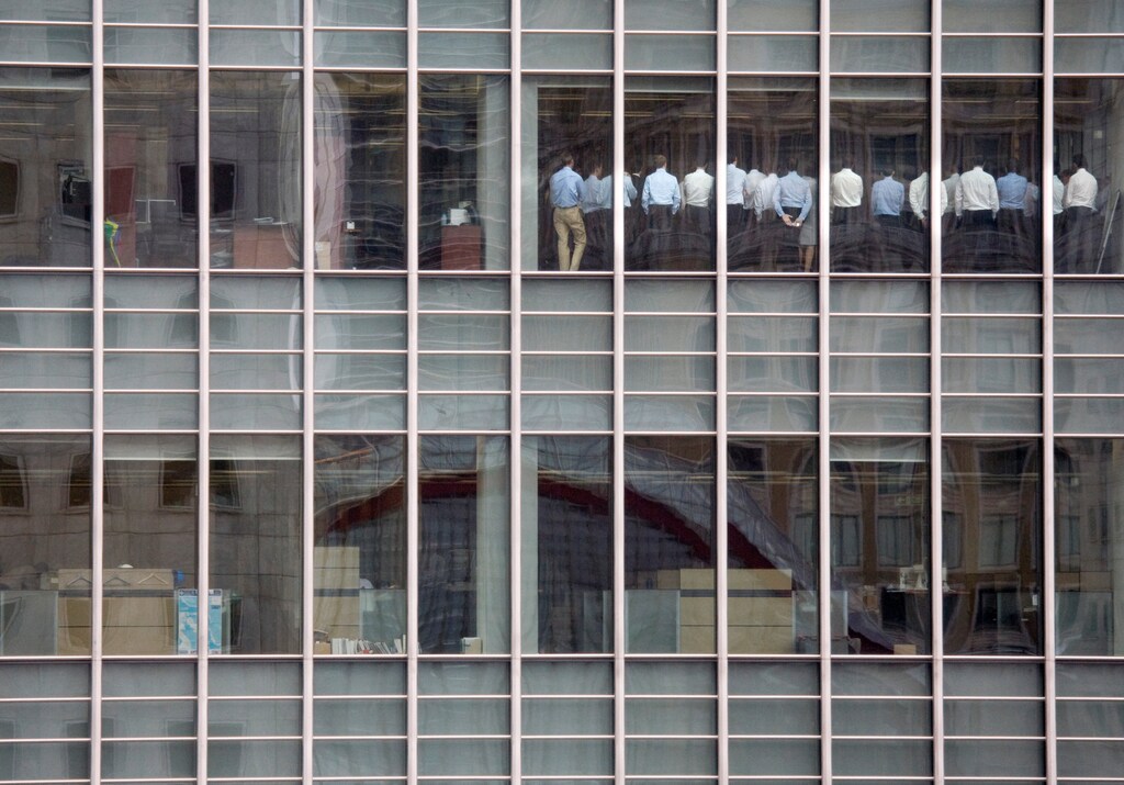 Bankers attend an emergency meeting at the London office of Lehman Brothers, in the financial district of Canary Wharf in London, Britain, September 11, 2008. The photograph caught the moment when Gwion Moore, one of those pictured in the photograph, and his colleagues were being told by bosses that things were going to be OK, despite the plummeting Lehman Brothers share price. "Senior management thought they needed to get the workforce focused again," Moore said. "The phrase was stop 'goofing around and get back to work'. I don't think anyone took the message very seriously because we went back to doing what we had been doing beforehand. No one was going to trade with us." REUTERS/Kevin Coombs/File photo SEARCH "LEHMAN 10" FOR THIS STORY. SEARCH "WIDER IMAGE" FOR ALL STORIES. TPX IMAGES OF THE DAY. - RC163BD644D0