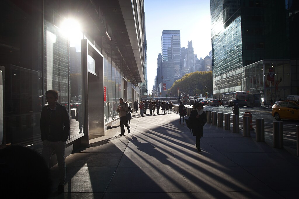 Commuters cast long shadows as they make their way through Times Square on a breezy and chilly fall morning in New York, November 18, 2014. REUTERS/Carlo Allegri (UNITED STATES - Tags: SOCIETY ENVIRONMENT) - GM1EABJ01YB01