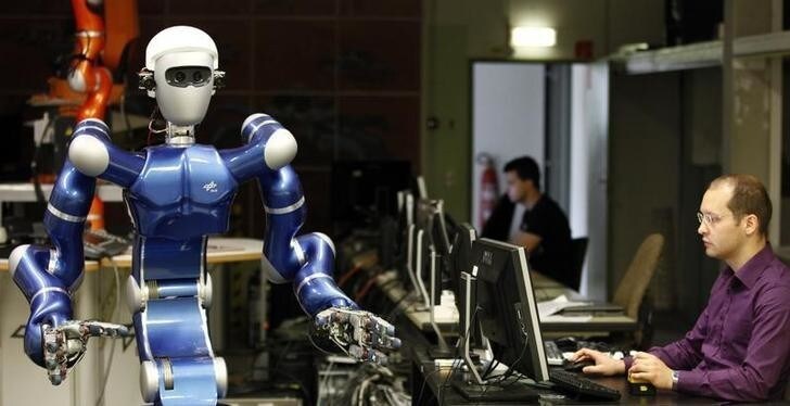 Alexander Dietrich of the German air and space agency, Deutsches Zentrum fuer Luft und Raumfahrt (DLR), works at humanoid two arm system robot Justin during a presentation in Oberpfaffenhofen near Munich June 1, 2011. The mobile robotic system Justin with its compliant controlled light weight arms and its two four finger hands allows the long range autonomous operation of the system. Sensors and cameras allow the 3D reconstruction of the robot's environment and therefore enable Justin to perform given tasks autonomously such as catching balls or serving coffee. REUTERS/Michael Dalder(GERMANY - Tags: SOCIETY SCI TECH)