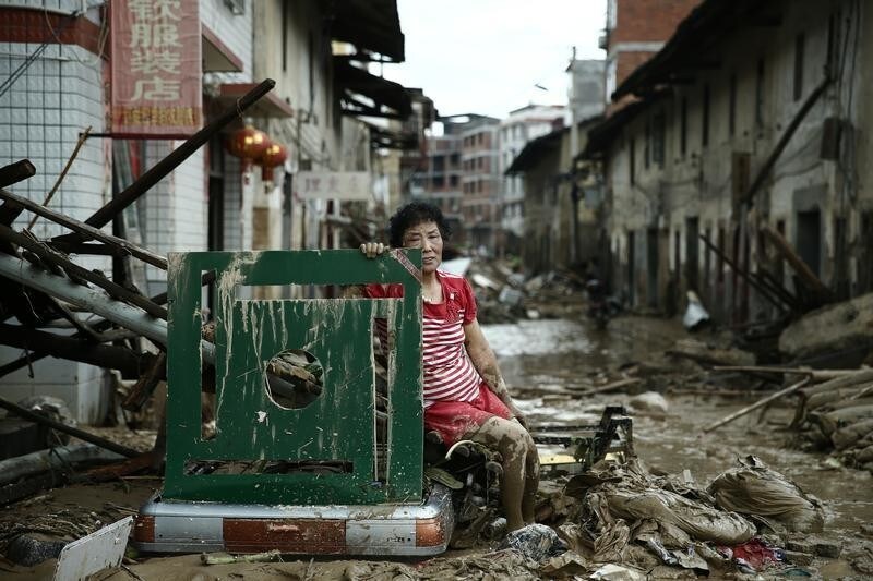 A woman sits on the ruins after typhoon Nepartak swept through Minqing county, Fujian province, China, July 10, 2016. Picture taken July 10, 2016. REUTERS/Stringer REUTERS ATTENTION EDITORS - THIS IMAGE WAS PROVIDED BY A THIRD PARTY. EDITORIAL USE ONLY. CHINA OUT. NO COMMERCIAL OR EDITORIAL SALES IN CHINA. TPX IMAGES OF THE DAY - S1AETOXMOIAA