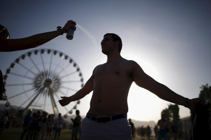A man is sprayed with sunscreen at the Coachella Valley Music and Arts Festival in Indio, California April 11, 2015. REUTERS/Lucy Nicholson