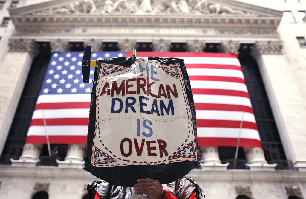 A demonstrator holds a sign reading "the American dream is over" during a rally outside Wall Street in New York April 4,2009. REUTERS/Shannon Stapleton (UNITED STATES BUSINESS SOCIETY IMAGE OF THE DAY TOP PICTURE) - GM1E54507NA01