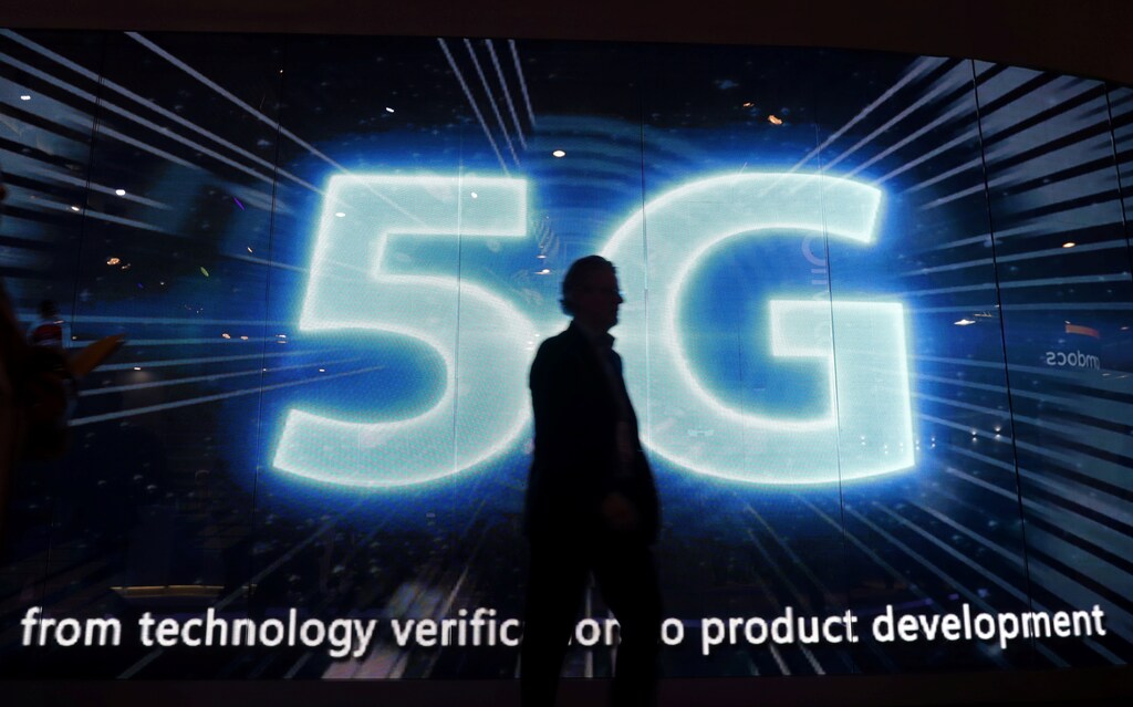 A visitors walks past a 5G sign during Mobile World Congress in Barcelona, Spain, February 28, 2017