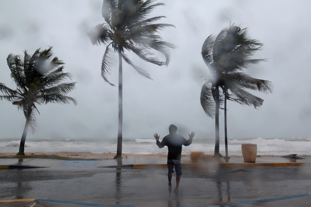 A man reacts in the winds and rain as Hurricane Irma slammed across islands in the northern Caribbean on Wednesday, in Luquillo, Puerto Rico September 6, 2017. REUTERS/Alvin Baez TPX IMAGES OF THE DAY - RC14353ED7A0