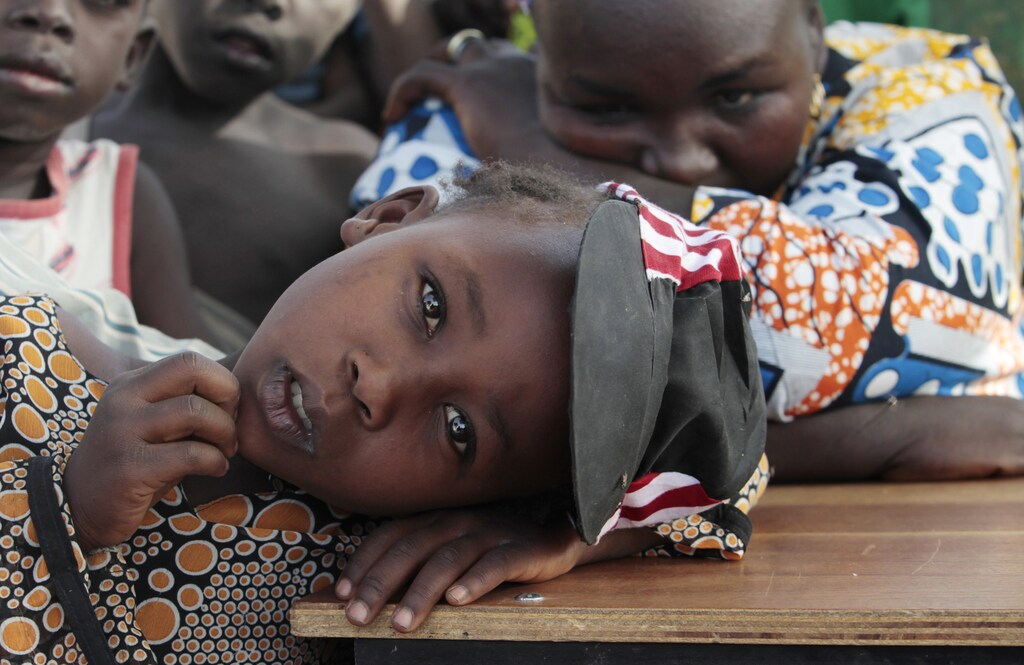 A girl displaced as a result of Boko Haram attack in the northeast region of Nigeria, rests her head on a desk at Maikohi secondary school camp for internally displaced persons (IDP) in Yola, Adamawa State January 13, 2015. Boko Haram says it is building an Islamic state that will revive the glory days of northern Nigeria's medieval Muslim empires, but for those in its territory life is a litany of killings, kidnappings, hunger and economic collapse. Picture taken January 13, 2015. To match Insight NIGERIA-BOKOHARAM/ REUTERS/Afolabi Sotunde (NIGERIA - Tags: CIVIL UNREST SOCIETY EDUCATION) - GM1EB1K0WBG01