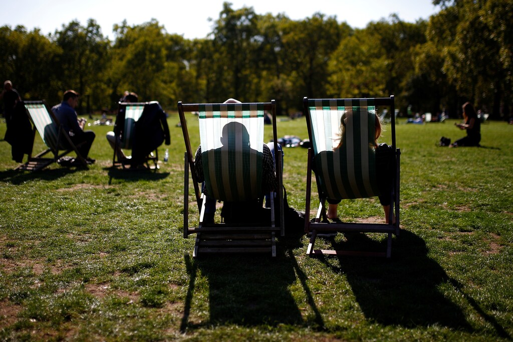 A couple enjoy the autumnal sunshine whilst sitting in a park in central London, Britain, September 13, 2018. REUTERS/Henry Nicholls