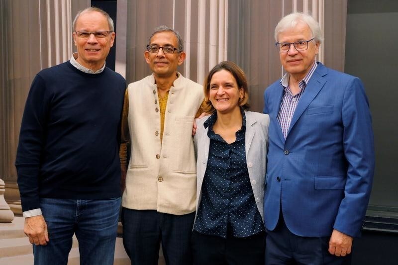 Abhijit Banerjee and Esther Duflo, two of the three winners of the 2019 Nobel Prize in Economics, pose for a photograph with 2016 Nobel Prize in Economics laureate Bengt Holstrom and 2014 laureate Jean Tirole at the Massachusetts Institute of Technology (MIT) in Cambridge, Massachusetts, U.S., October 14, 2019. REUTERS/Brian Snyder - RC1889161B00