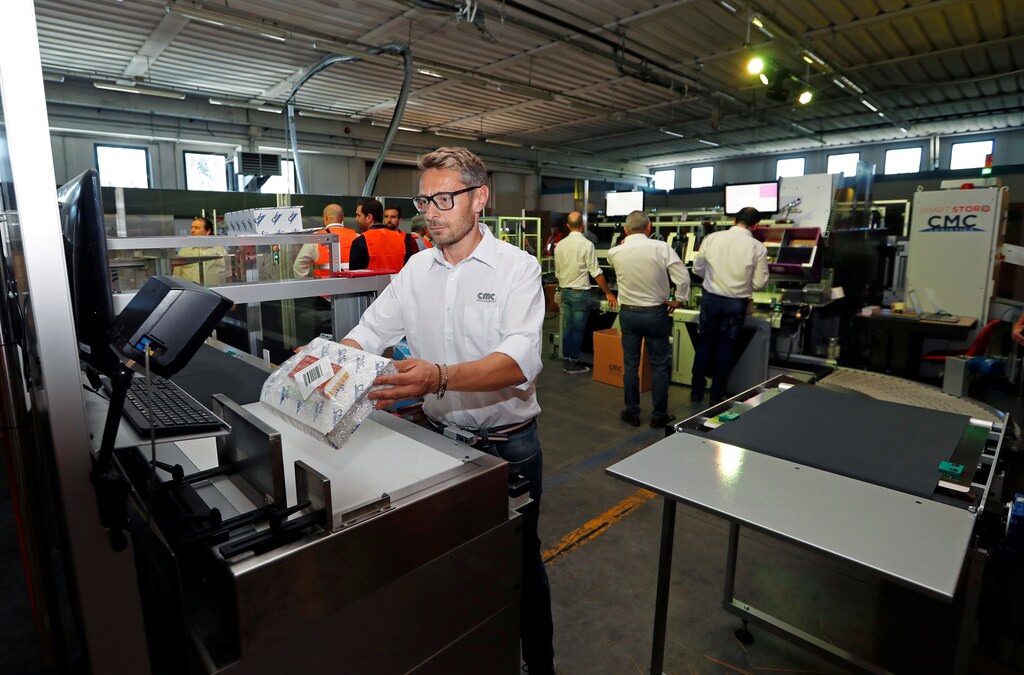 An employee scans a code on a package at a factory of Italian packaging company CMC Srl in Citta di Castello, Italy, June 25, 2019. Picture taken June 25, 2019. REUTERS/Remo Casilli - RC1F79D03FA0