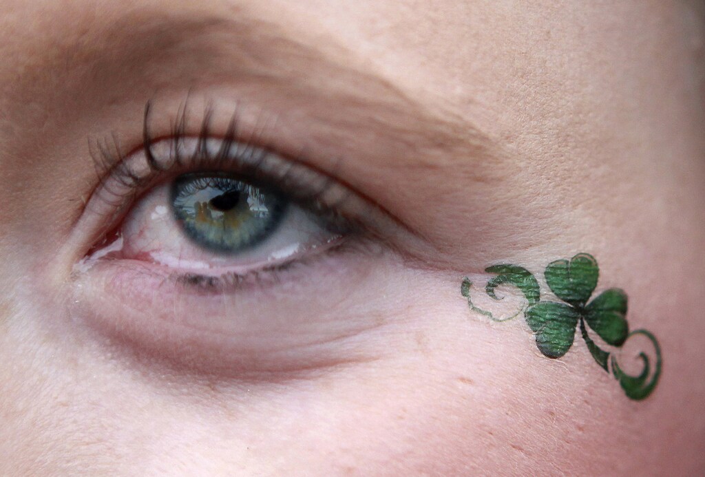A reveller has a shamrock painted on her face during Saint Patrick's Day celebrations in the town of Portstewart, County Londonderry