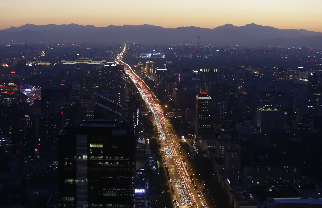 Vehicles are seen on a main avenue during the evening rush hour at sunset in Beijing September 3, 2014.