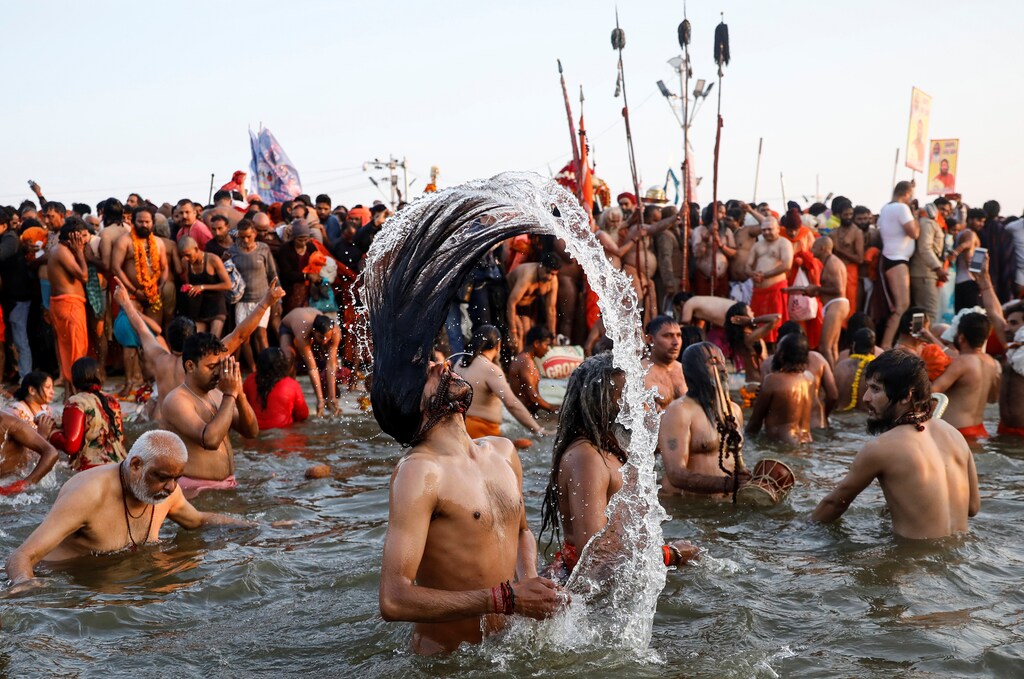 Naga Sadhus or Hindu holy men take a dip during the first "Shahi Snan" (grand bath) at "Kumbh Mela" or the Pitcher Festival, in Prayagraj, previously known as Allahabad, India, January 15, 2019. REUTERS/Danish Siddiqui - RC161F967460