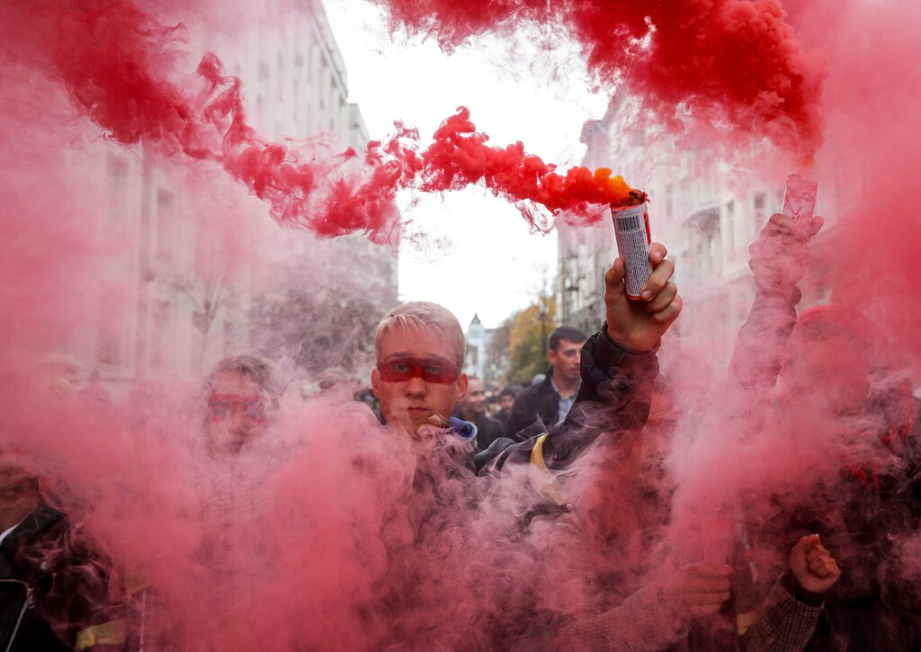 People burn flares during a rally against the approval of the so-called Steinmeier Formula, in Kiev, Ukraine October 6, 2019. REUTERS/Valentyn Ogirenko TPX IMAGES OF THE DAY - RC1262729CC0