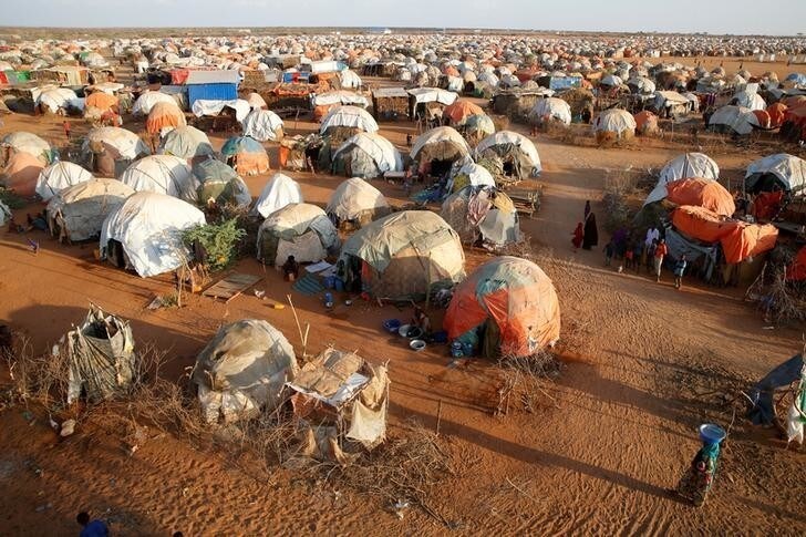 A woman walks past makeshift shelters at the new Kabasa internally displaced camp in the northern Somali town of Dollow, Somalia, February 25, 2018.picture taken February 25, 2018. REUTERS/Baz Ratner