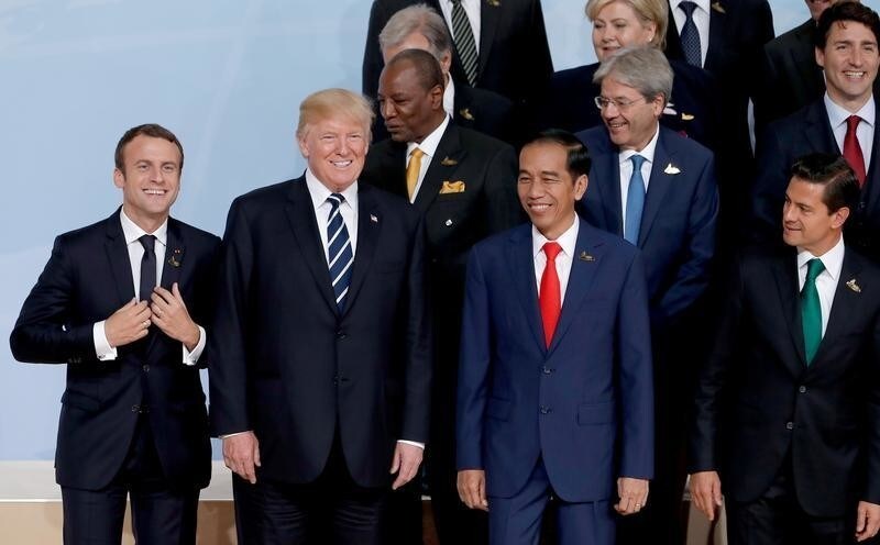 French President Emmanuel Macron and U.S. President Donald Trump take part in a family photo with other leaders during the G20 leaders summit in Hamburg, Germany, July 7, 2017. REUTERS/Ian Langsdon/Pool - RC1738D12620