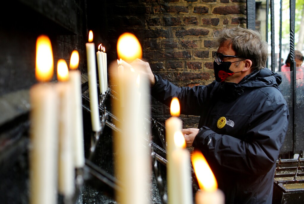 A faithful lights a candle outside the church, after the first mass open for believers after the closing of church services due to the spread of the coronavirus disease (COVID-19), in Kevelaer, Germany May 1, 2020. REUTERS/Thilo Schmuelgen - RC2NFG9XB3BA