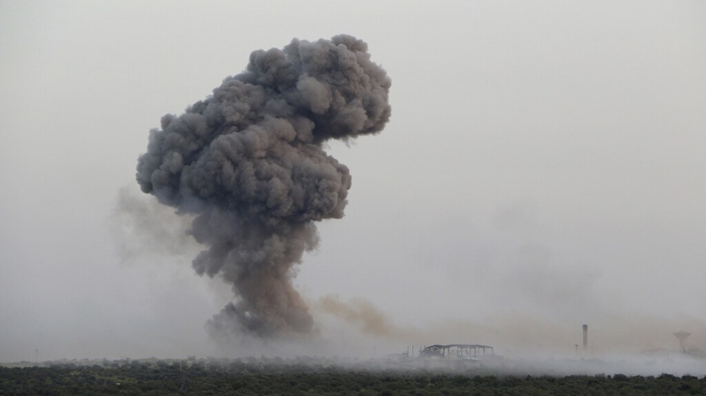 Smoke rises from Qarmeed camp after who Islamist rebel fighters said was a suicide bomber from al Qaeda's Nusra Front drove a truck packed with explosives into the compound and blew it up, in northwestern Idlib province April 26, 2015. A coalition of Islamist rebels seized the army base in northwestern Syria at dawn on Monday after the suicide bomber from al Qaeda's Nusra Front drove a truck packed with explosives into the compound and blew it up. The capture of Qarmeed camp, reported by a rebel commander and social media videos showing militants inside the base, brought the coalition closer to seizing most of Idlib province and moving toward Latakia, the ancestral home of Syrian President Bashar al-Assad. Picture taken April 26, 2015. REUTERS/Ammar Abdullah TPX IMAGES OF THE DAY - GF10000074338