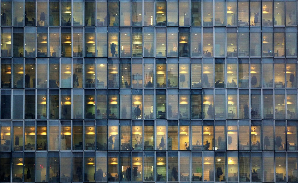 Lights are on as people work in their offices in a skyscraper in downtown Milan, February 17, 2015.