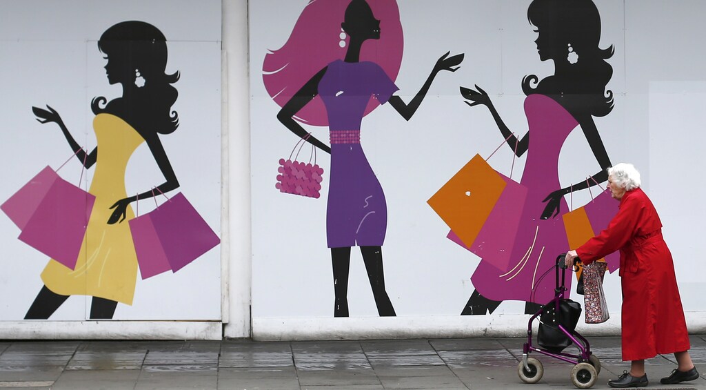 A shopper walks past an empty retail unit in Nottingham, central England, June 6, 2013. REUTERS/Darren Staples (BRITAIN - Tags: BUSINESS) - LM1E96613TI01