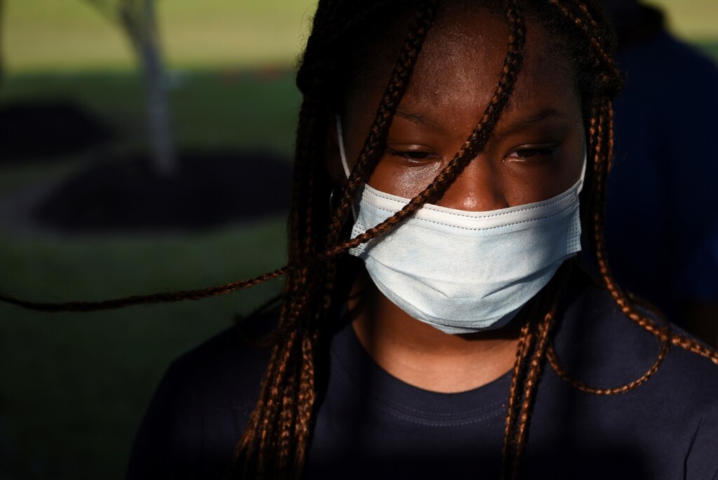 A young woman sheds a tear as people visit the gravesite of George Floyd, whose death in Minneapolis police custody has sparked nationwide protests against racial inequality, in Pearland, Texas, U.S., June 9, 2020. REUTERS/Callaghan O'Hare - RC216H97NFT4