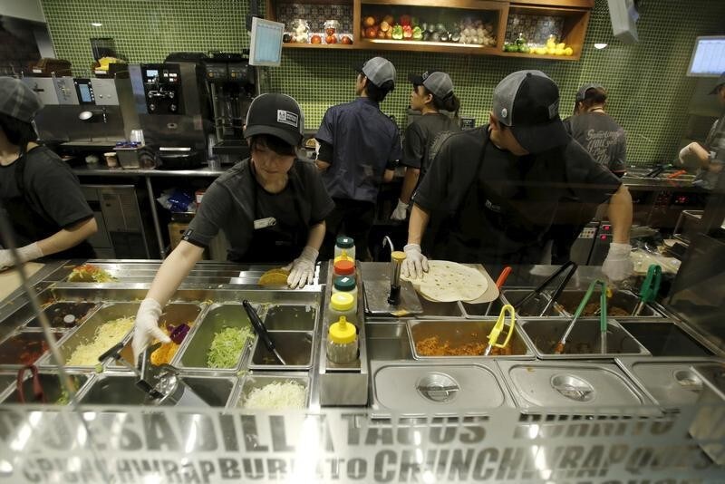 Staff work in the kitchen at the first Taco Bell fast-food restaurant in Japan at Tokyo's Shibuya shopping district April 21, 2015. America's Mexican fast food franchise, Taco Bell, opened its first Japanese outlet in one of Tokyo's busiest shopping district, Shibuya on Tuesday morning. REUTERS/Toru Hanai - GF10000067115