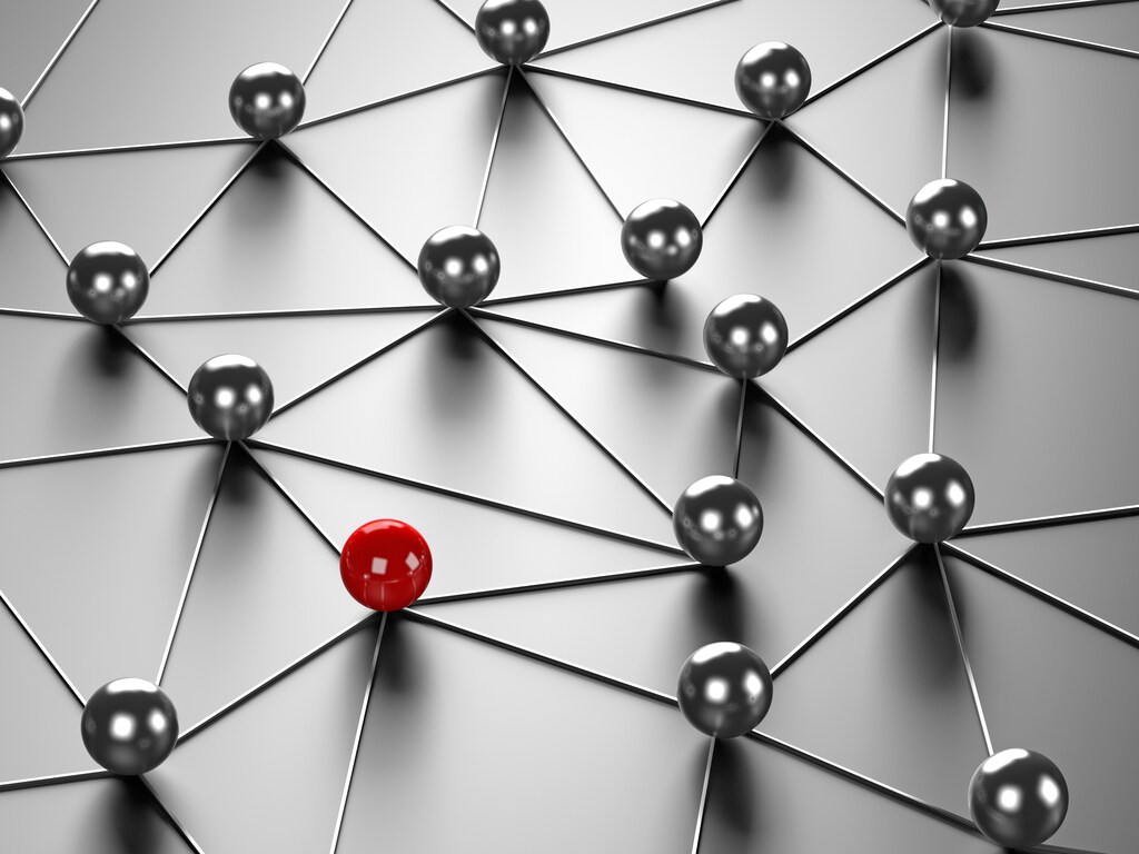 gráfico de bolas de distintos colores conectadas por cables, incluida una roja, en un blog sobre liderazgo