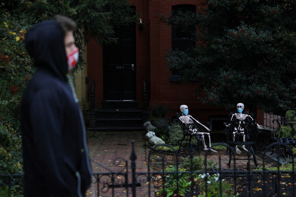 Decorative Halloween skeletons wearing protective face masks are seen along 16th Street, amid the coronavirus disease (COVID-19) outbreak, in Washington, U.S., October 28, 2020. REUTERS/Tom Brenner - RC2URJ9W32NQ