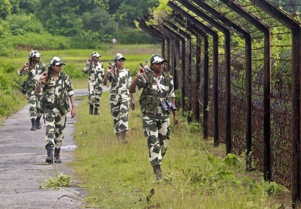 Female personnel of India's Border Security Force (BSF) patrol along the fencing of the India-Bangladesh international border ahead of India's Independence Day celebrations, at Dhanpur village in India's northeastern state of Tripura August 11, 2014. India commemorates its Independence Day on August women men female male girls boys teenagers teens development gender gap parity india indian equality diversity progress change femmine masuline woman man sex biology roles dynamic balance bias androgynous