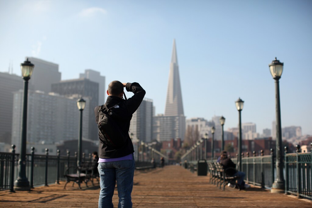 A man photographs the TransAmerica building from Pier 7 in San Francisco, California January 25, 2013.